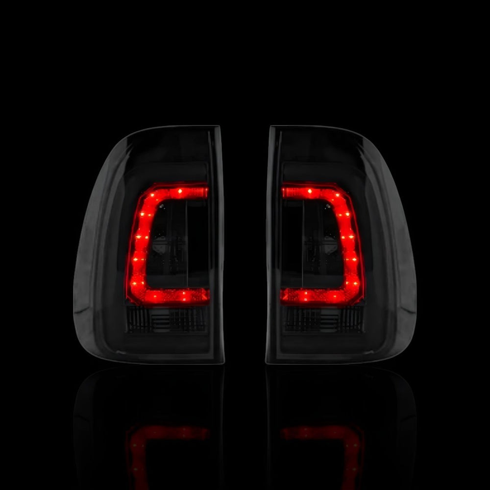 
                  
                    Smoked Black 3D Stripe Bar LED Tail Lights – Fits Toyota Hilux N80 / Revo Rocco (2015–2024) | LH + RH Pair - Blckline Automotive
                  
                
